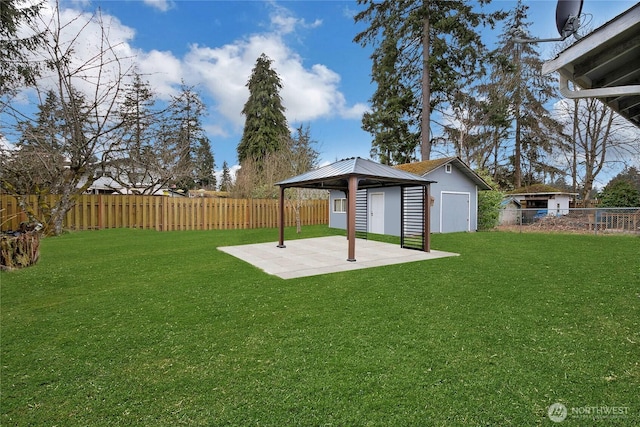 view of yard featuring a patio, a fenced backyard, an outdoor structure, a gazebo, and a storage unit