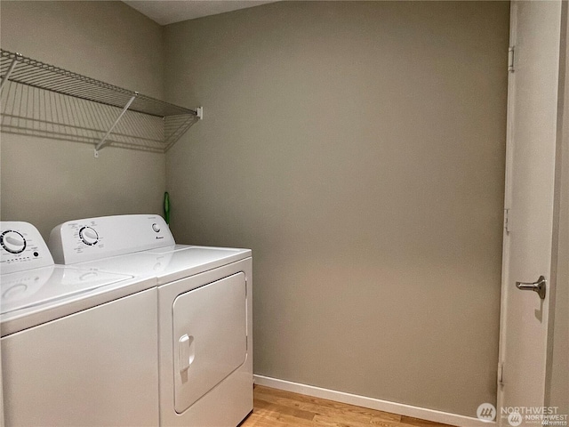 laundry room with laundry area, independent washer and dryer, light wood-style flooring, and baseboards