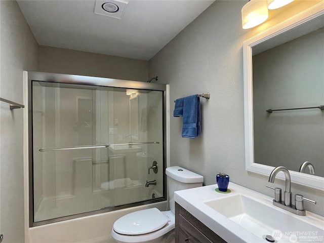 full bath with toilet, combined bath / shower with glass door, and vanity