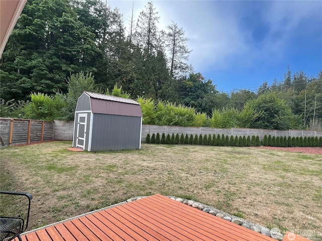 view of yard with a storage shed, an outdoor structure, and a fenced backyard