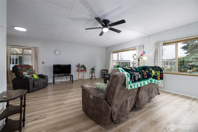 living room with ceiling fan and light wood-style flooring