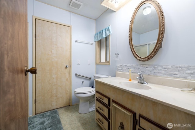 bathroom with visible vents, vanity, and toilet