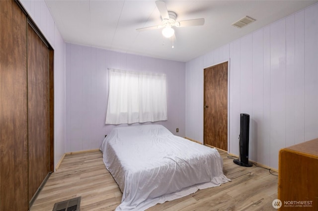 bedroom with a ceiling fan, a closet, visible vents, and light wood finished floors