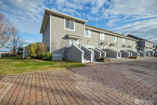 view of front of home with a front lawn and a residential view