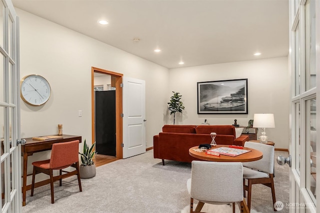 living room featuring recessed lighting, french doors, and light colored carpet