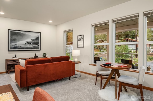 living room featuring recessed lighting, light carpet, and baseboards