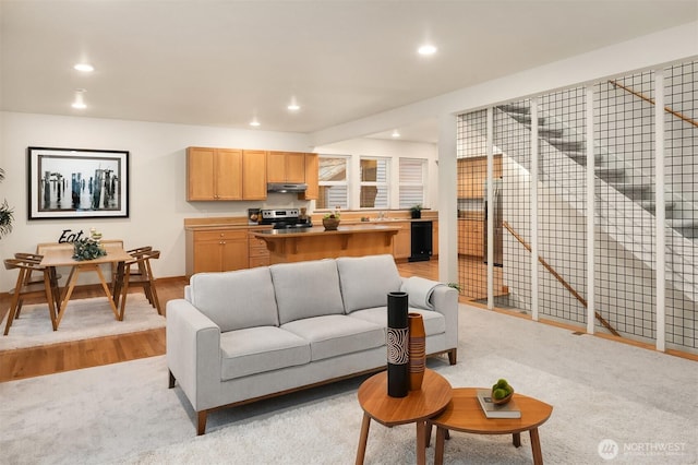 living room with light wood-style floors and recessed lighting