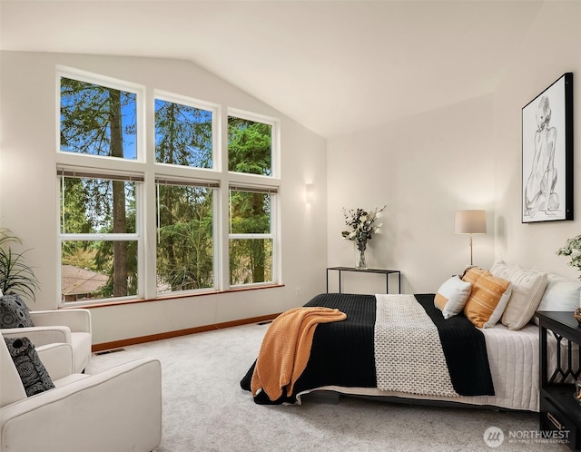 carpeted bedroom with visible vents, multiple windows, baseboards, and vaulted ceiling