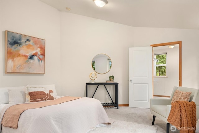 bedroom with carpet, vaulted ceiling, and baseboards