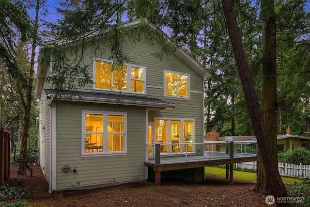 back of house with a deck, crawl space, and fence