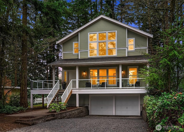 exterior space featuring stairs, driveway, and a garage