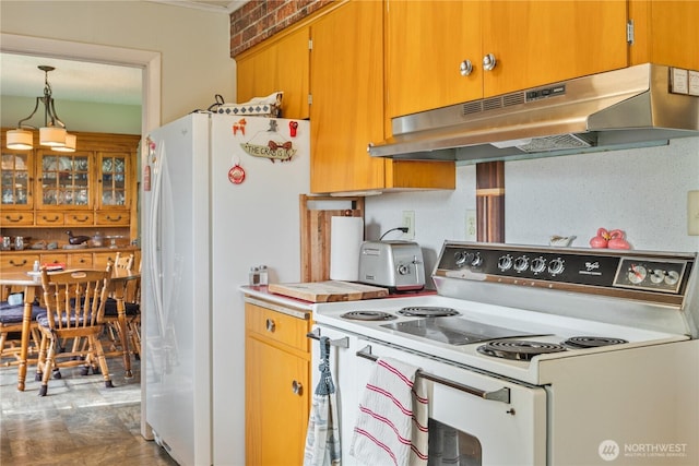 kitchen with under cabinet range hood, white appliances, hanging light fixtures, and light countertops