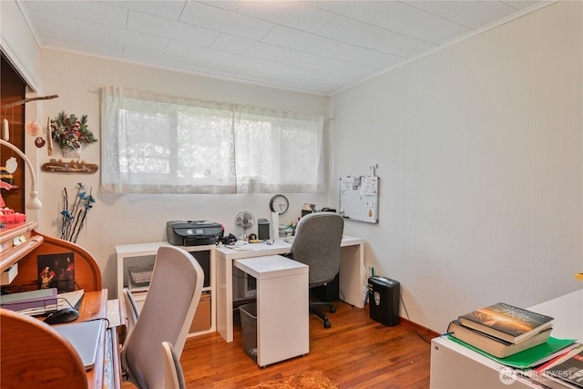 home office featuring crown molding and wood finished floors