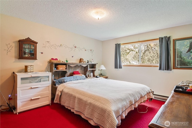 bedroom featuring a baseboard heating unit and a textured ceiling