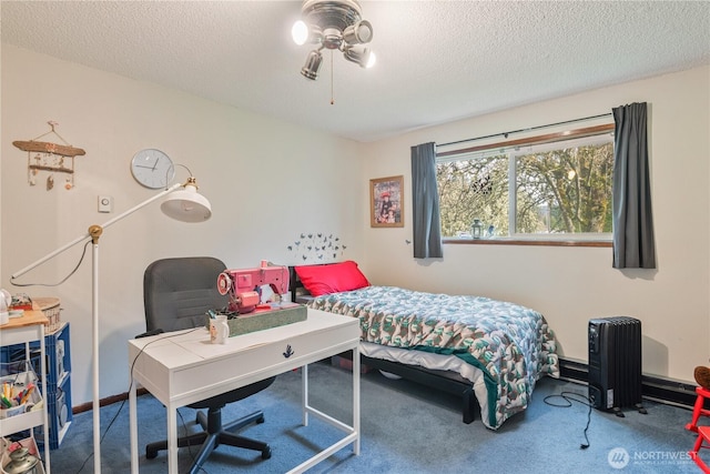 bedroom with baseboards, carpet floors, and a textured ceiling