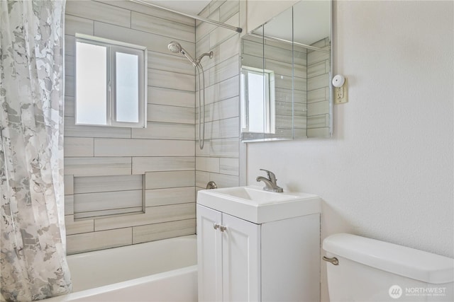 bathroom with shower / bath combination with curtain, toilet, and vanity