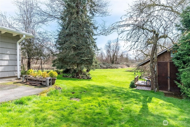 view of yard featuring an outbuilding and a deck