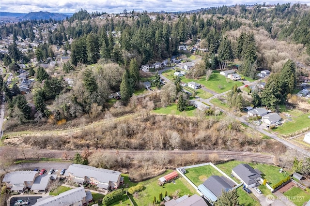 birds eye view of property featuring a view of trees