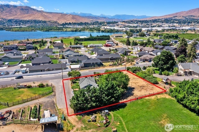 bird's eye view featuring a residential view and a water and mountain view