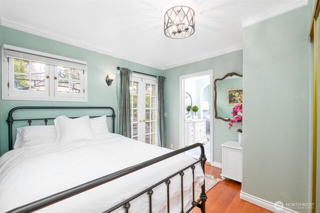 bedroom with ornamental molding, connected bathroom, baseboards, and wood finished floors