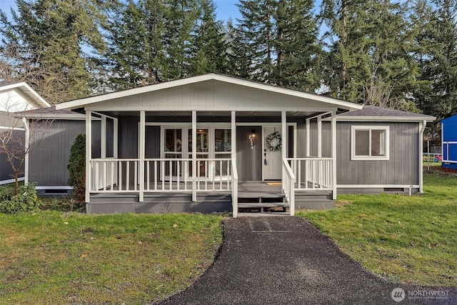 view of front of home with crawl space, covered porch, a front lawn, and roof with shingles