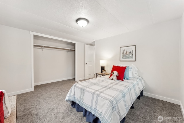 carpeted bedroom with a textured ceiling, a closet, and baseboards