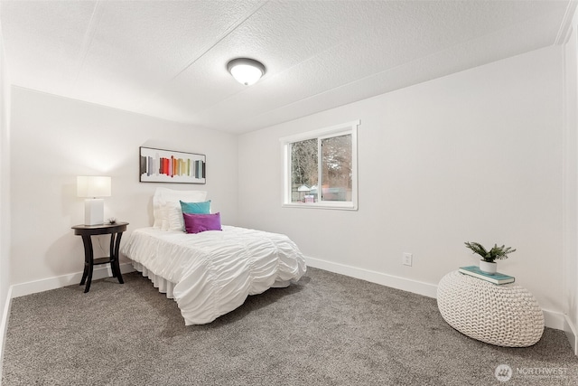 bedroom featuring carpet, baseboards, and a textured ceiling