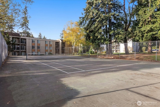 view of tennis court featuring fence