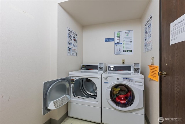 clothes washing area featuring washing machine and dryer