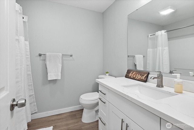 full bathroom with curtained shower, toilet, wood finished floors, vanity, and baseboards