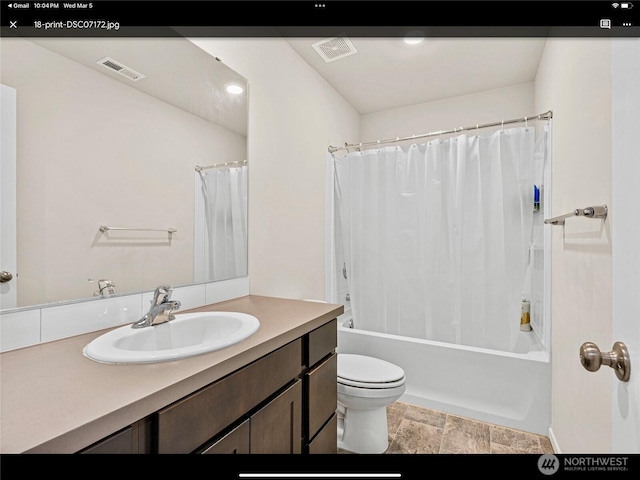 5609 151st Street Ct E, Puyallup, WA 98375 - full bathroom featuring vanity, toilet, shower / bath combo, and stone finish floors