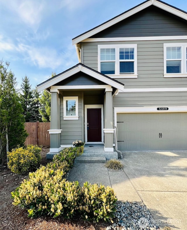 5609 151st Street Ct E, Puyallup, WA 98375 - view of front of house with fence, an attached garage, and driveway