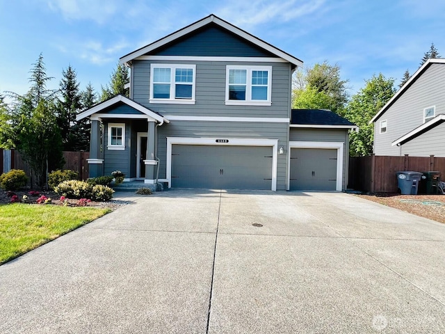 5609 151st Street Ct E, Puyallup, WA 98375 - view of front of house featuring fence, concrete driveway, and a garage