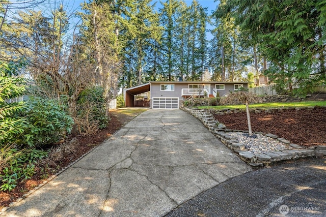 view of front facade with a carport, driveway, and a chimney