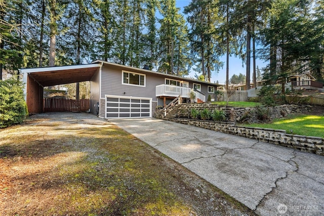 view of front of house featuring driveway, fence, stairway, and a carport