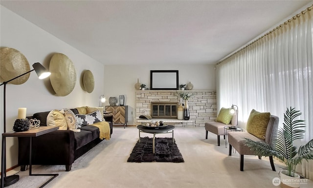 carpeted living area with a stone fireplace