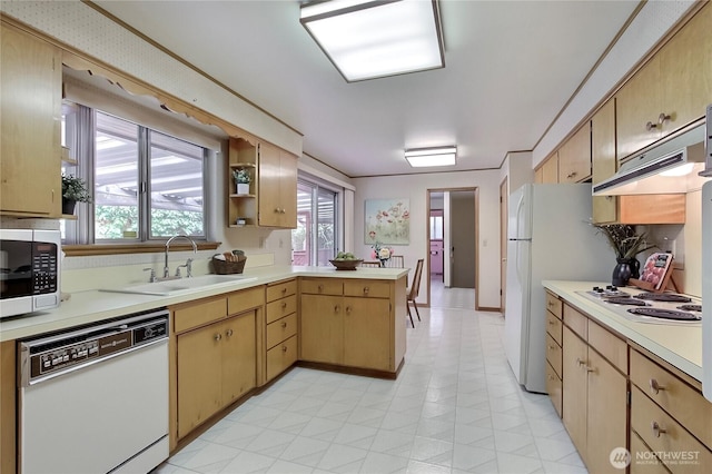 kitchen with white appliances, light countertops, and a peninsula