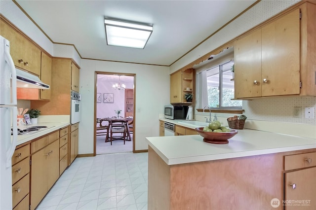 kitchen with a sink, white appliances, a peninsula, crown molding, and light countertops