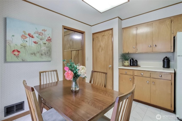 dining area featuring visible vents, wallpapered walls, and crown molding