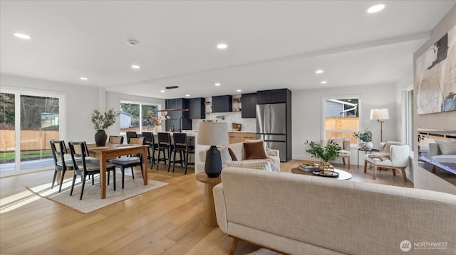 living area featuring light wood-type flooring and recessed lighting