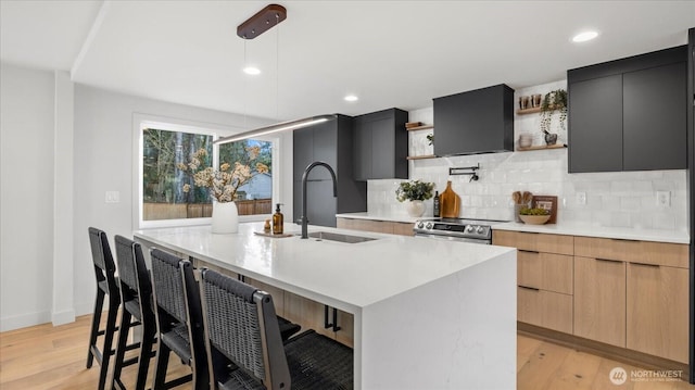 kitchen featuring open shelves, stainless steel electric range oven, modern cabinets, and a sink