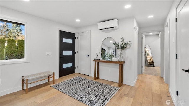 entryway featuring recessed lighting, baseboards, light wood finished floors, and a wall mounted AC