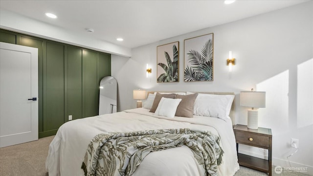 bedroom with light carpet, recessed lighting, and baseboards