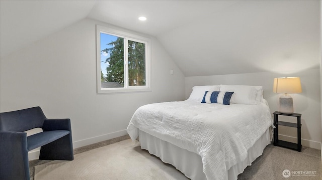 carpeted bedroom with baseboards and vaulted ceiling