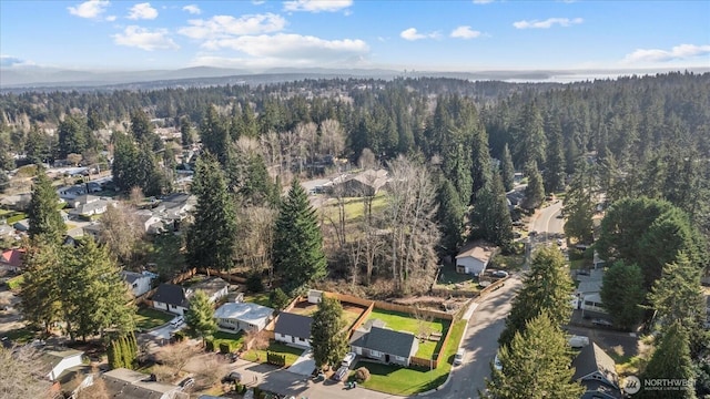 birds eye view of property featuring a view of trees