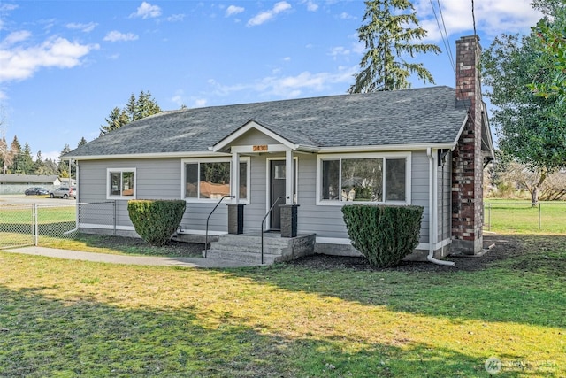 view of front of property featuring a chimney, a shingled roof, a front lawn, and fence