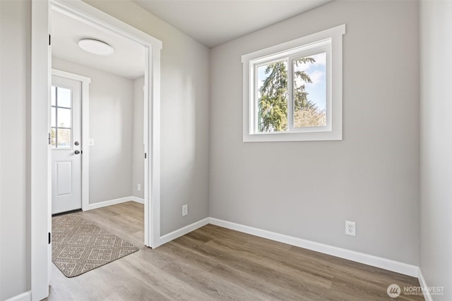 empty room featuring baseboards and wood finished floors