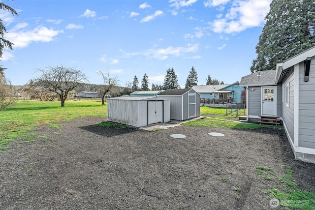 view of yard featuring entry steps, a storage shed, and an outdoor structure