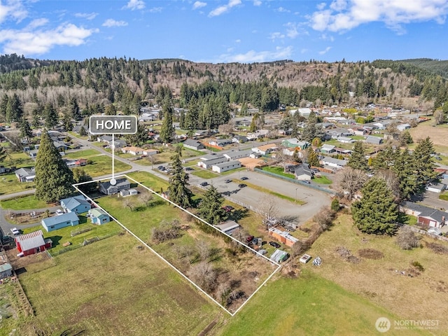 birds eye view of property featuring a view of trees