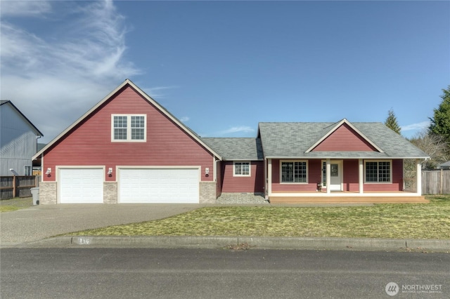 view of front of house featuring covered porch, fence, driveway, roof with shingles, and a front yard